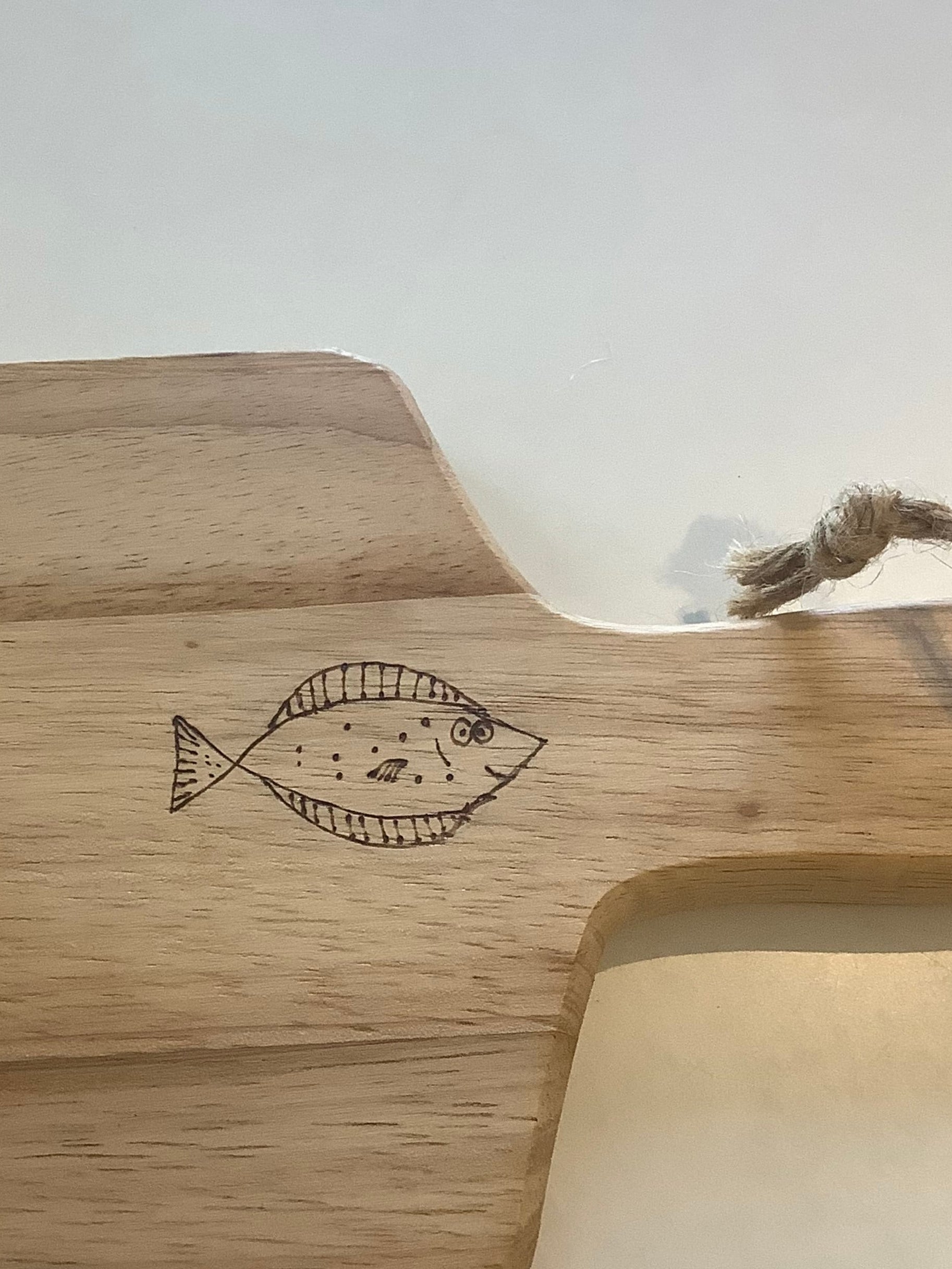 Hand-decorated Acacia wood serving board with Happy Plaice fish design