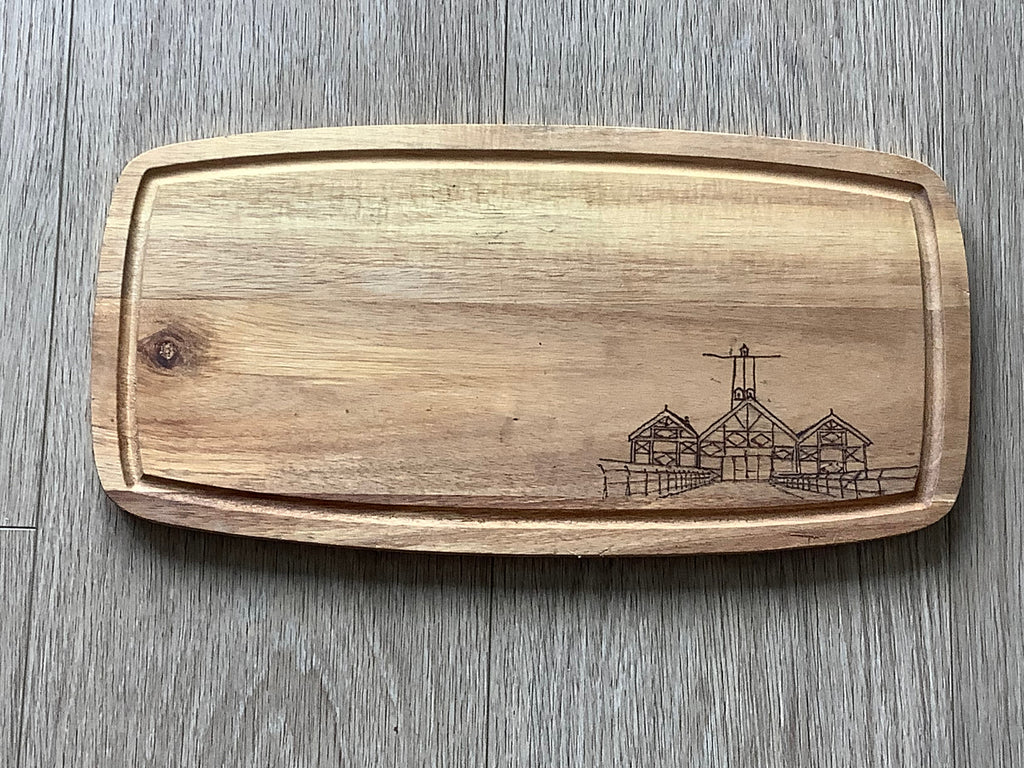 Detailed hand-burned pyrography illustration of Saltburn Pier amusements on a small acacia wood serving board by Saltburn Coastal Art ideal for home or gifting