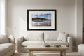 Saltburn from the Sea landscape coastal photography print in a black frame with white mount, displayed on a wall in a bright modern coastal home interior with natural linen and pale wood accents